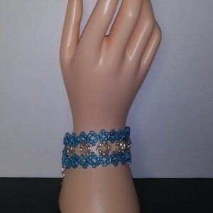 Handmade bracelet with beads in shades of water blue and white.
